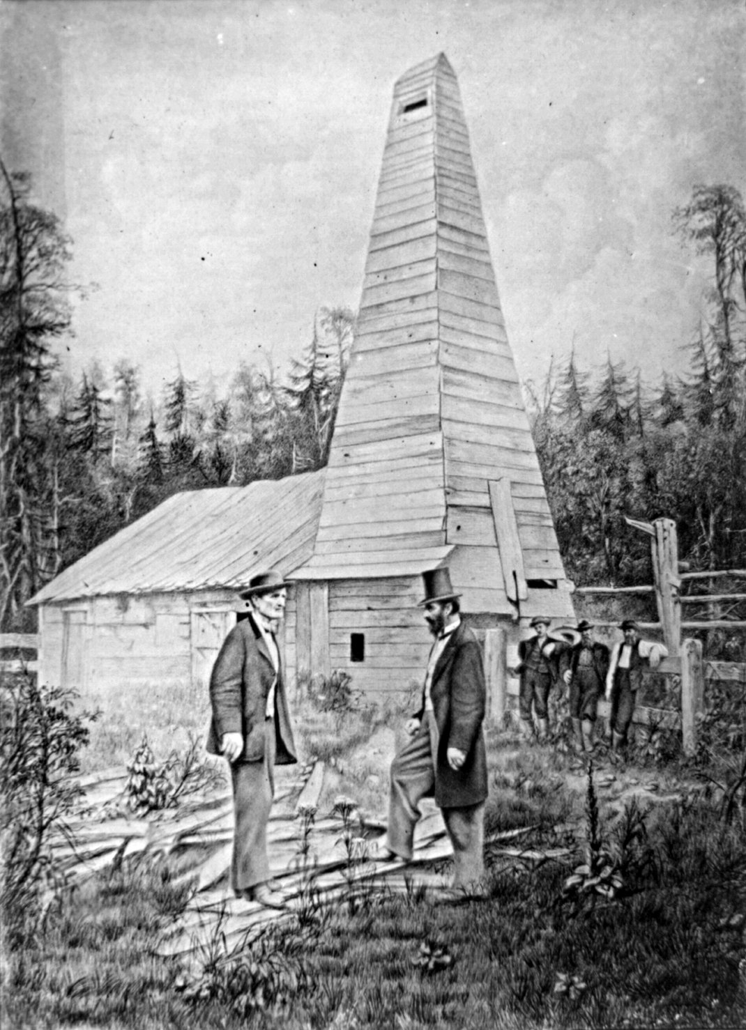 Retouched photograph showing Edwin L. Drake, to the right, and the Drake Well in the background, in Titusville, Pennsylvania, where the first commercial well was drilled in 1859 to find oil