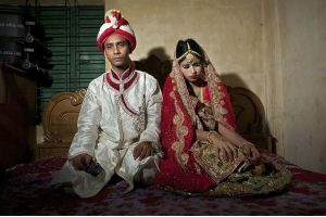 Photo of 32 year-old Mohammad Hasamur Rahman with his new bride, 15-year-old Nasoin Akhter, in Manikganj, Bangladesh