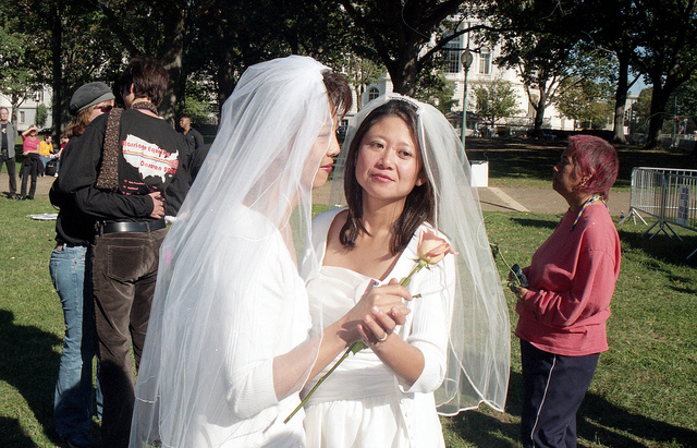 Photo of two brides dancing on the capitol grounds in Washington, D.C.