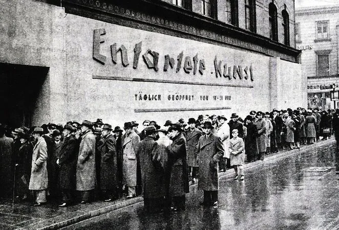 Photo of visitors waiting in line to see the Entartete Kunst exhibition at the Schulausstellungsgebaude, Hamburg. 