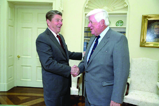 An image of Ronald Reagan shaking hands with Tip O'Neil.