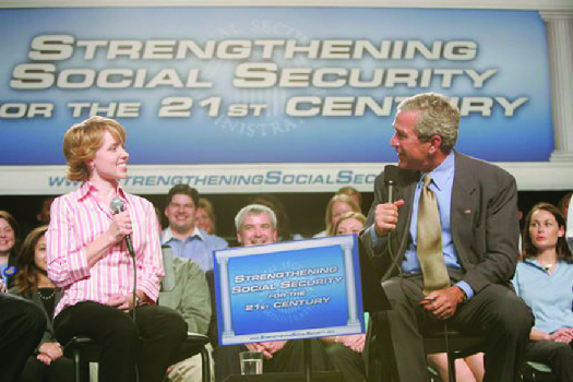 A photo of George W. Bush speaking at an event. The banner behind him says "Strengthening Social Security for the 21st Centur