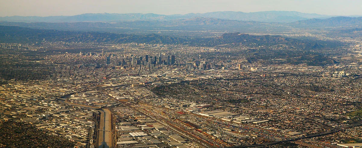 An aerial view of Los Angeles and its surrounding areas. The entire span of the picture contains buildings covering a large a