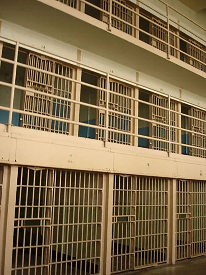 Two levels of empty prison cells are shown.