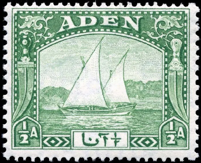 The postage stamp is white and green with a black border. The middle of the stamp shows a sailing ship with two masts in wate