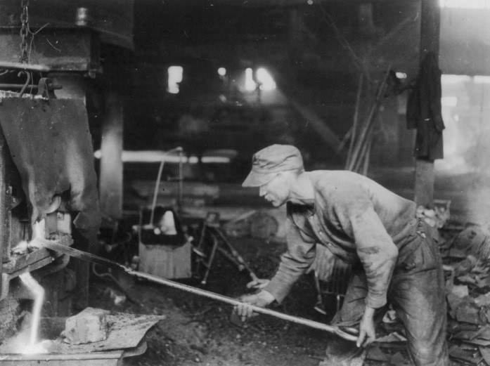 Figure 7.7 An iron puddler tapping steel from the furnace